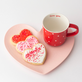 Vanilla heart-shaped Valentine's sugar cookies in pink, red and white royal icing with sprinkles