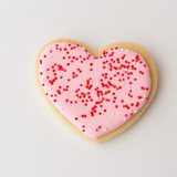 Vanilla heart-shaped Valentine's sugar cookies in pink, red and white royal icing with sprinkles